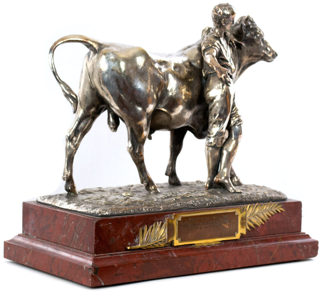 A silvered bronze group of a boy and steer