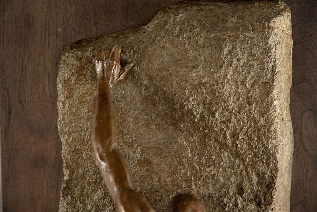 A Bronze Wall Sculpture of a Rock Climber by Jim Rennert